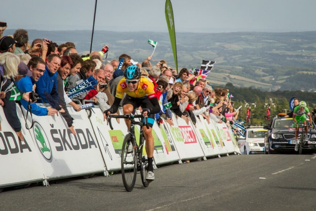 Bradley Wiggins rides past crowds at the top of Haytor