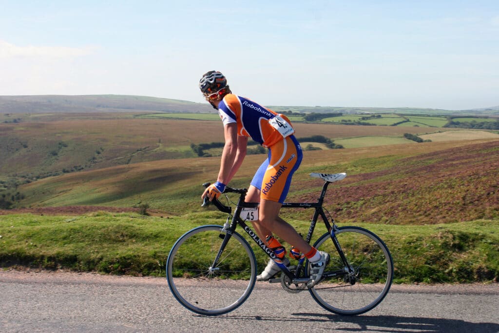 Cyclist riding in the sunshine through Exmoor National Park