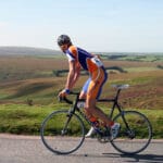 Cyclist riding in the sunshine through Exmoor National Park